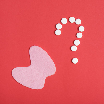 Stylized thyroid and tablets forming a question mark on a red background – symbol of thyroid medication