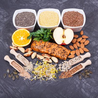 Salmon, seeds, nuts and fruit as nutrient-rich foods for a balanced diet – natural appearance