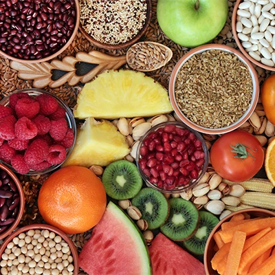 Colorful assortment of fruits, vegetables, legumes, nuts and grains – fiber-rich foods viewed from above